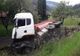 FOTO. Accident grav la Corbu. Bărbat lovit în fața porții de un camion răsturnat peste gard, în urma impactului cu un alt camion